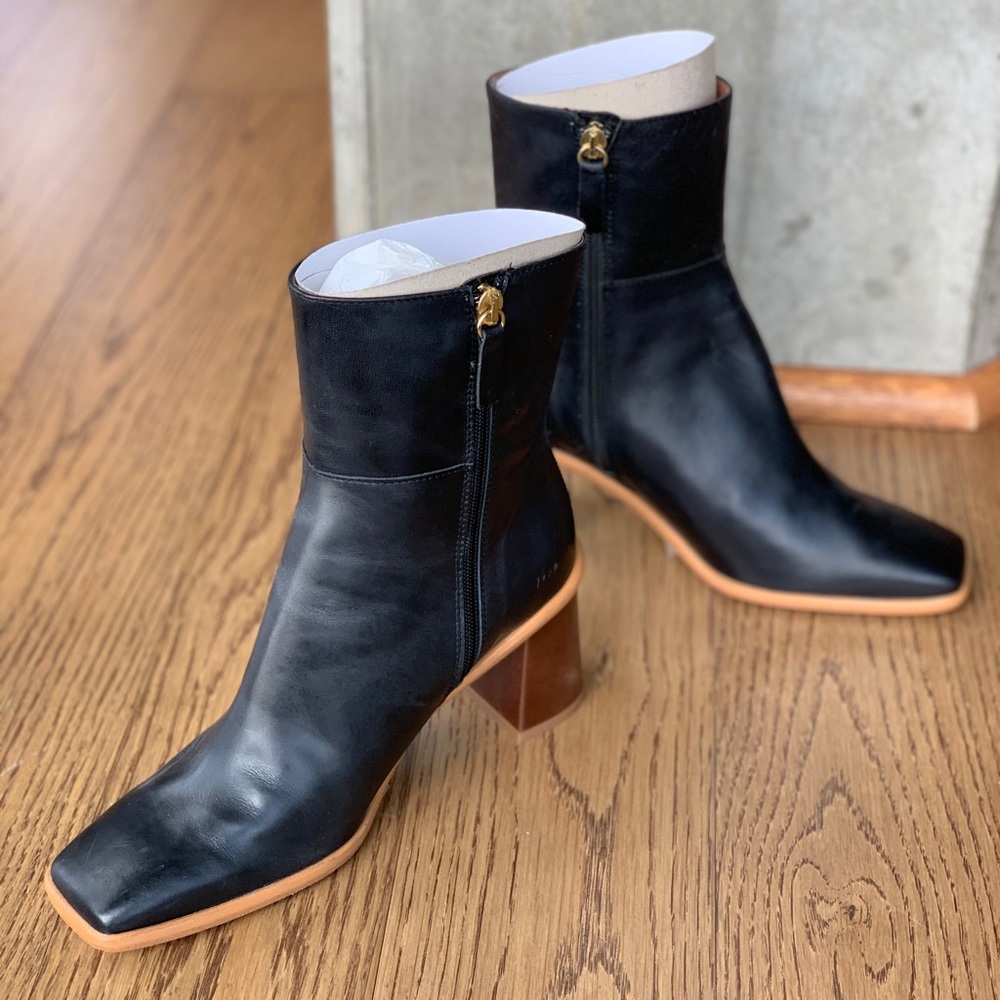 Sleek heeled leather boot with a square toe